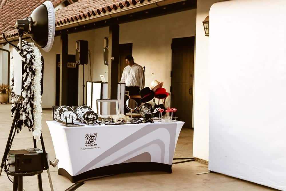 Pop Life Photo Booth setup featuring props and a backdrop for wedding guests, enhancing the fun atmosphere at Thomas and Anastasha's celebration.