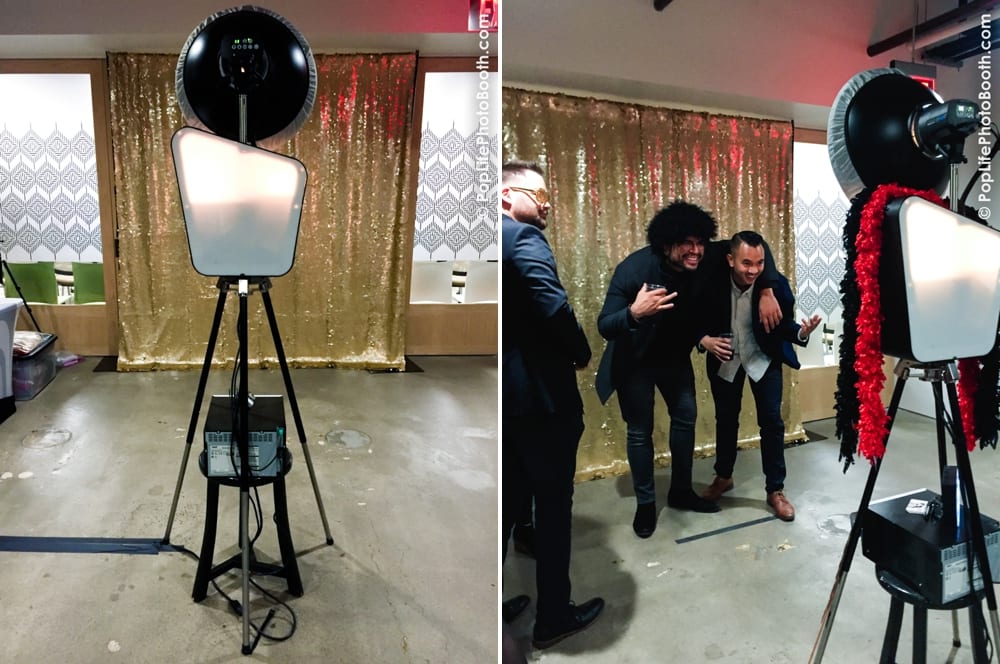 Photo booth setup with golden backdrop at a corporate Thanksgiving event, featuring guests posing with props and enjoying the photo experience.