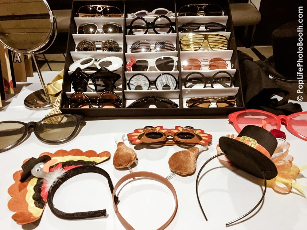 Thanksgiving-themed photo booth props including turkey hats, festive glasses, and decorative accessories at a corporate event hosted by Yelp.