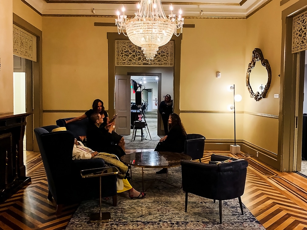 Elegant foyer of The General's Residence in San Francisco, featuring a chandelier, hardwood floors, and guests seated in plush chairs, ideal for events and gatherings.