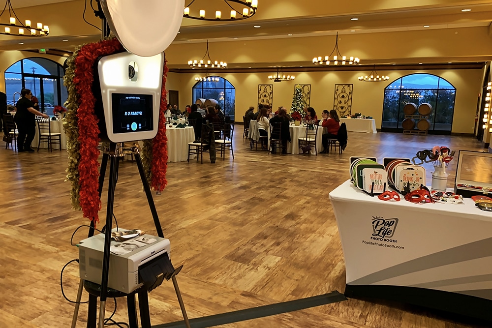 Pop Life Photo Booth setup in Garré Vineyard & Winery event space, featuring photo booth with props and guests enjoying the ambiance of a festive gathering.