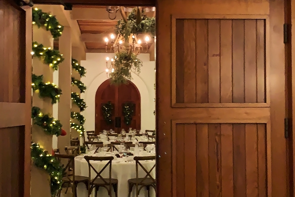 Elegant dining room setup at Wente Vineyards, featuring festive decorations, wooden accents, and a chandelier, ideal for events and celebrations in a luxurious rural setting.
