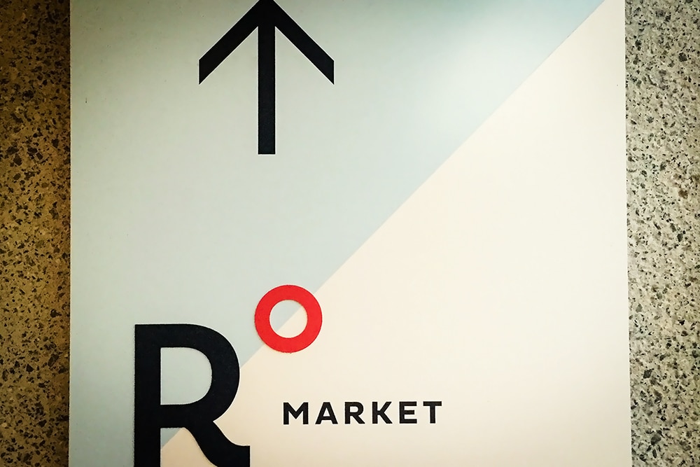 Roundhouse Market sign featuring directional arrow and modern design, representing a premier event venue in San Ramon for corporate events and gatherings.