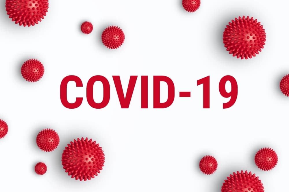 Red COVID-19 virus illustrations with the text "COVID-19" prominently displayed, symbolizing the importance of health safety measures during events.