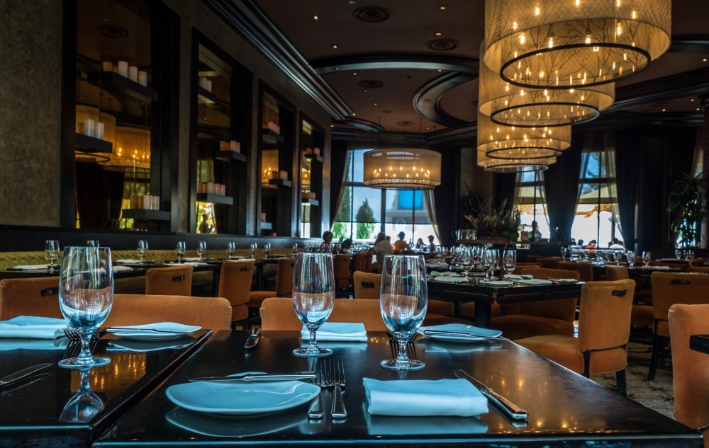 Elegant dining room in a Las Vegas casino, featuring stylish decor, glassware, and soft lighting, ideal for corporate events and networking opportunities.