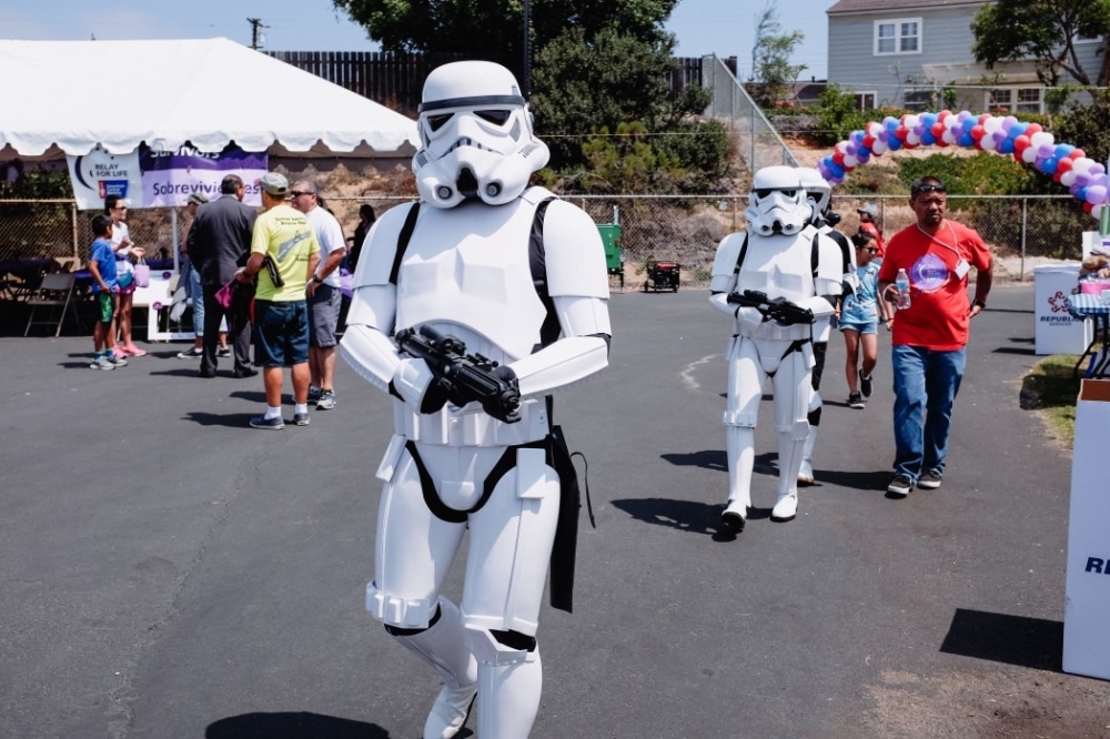 Stormtroopers in costume participating in a charity event, engaging guests and adding entertainment value to the fundraiser.