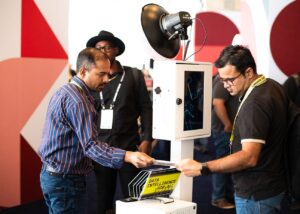 Attendees engaging with the Corporate Photo Booth at Databricks event, featuring interactive photo experience and custom props for networking and celebration.