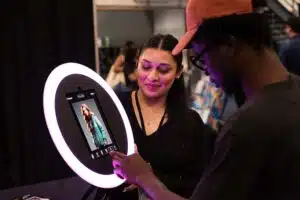Guests engaging with a modern photo booth setup featuring a ring light, capturing fun moments at a Northern California event, showcasing brand activation and social media sharing potential.