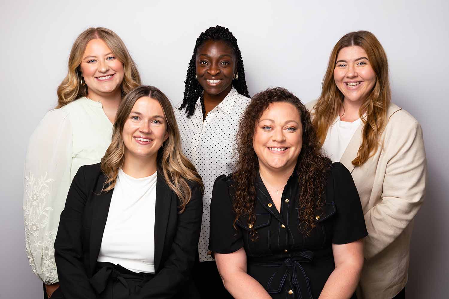 Group photo of five women smiling, representing RMC's family-driven team culture and commitment to connection and creativity in Healdsburg, Sonoma.