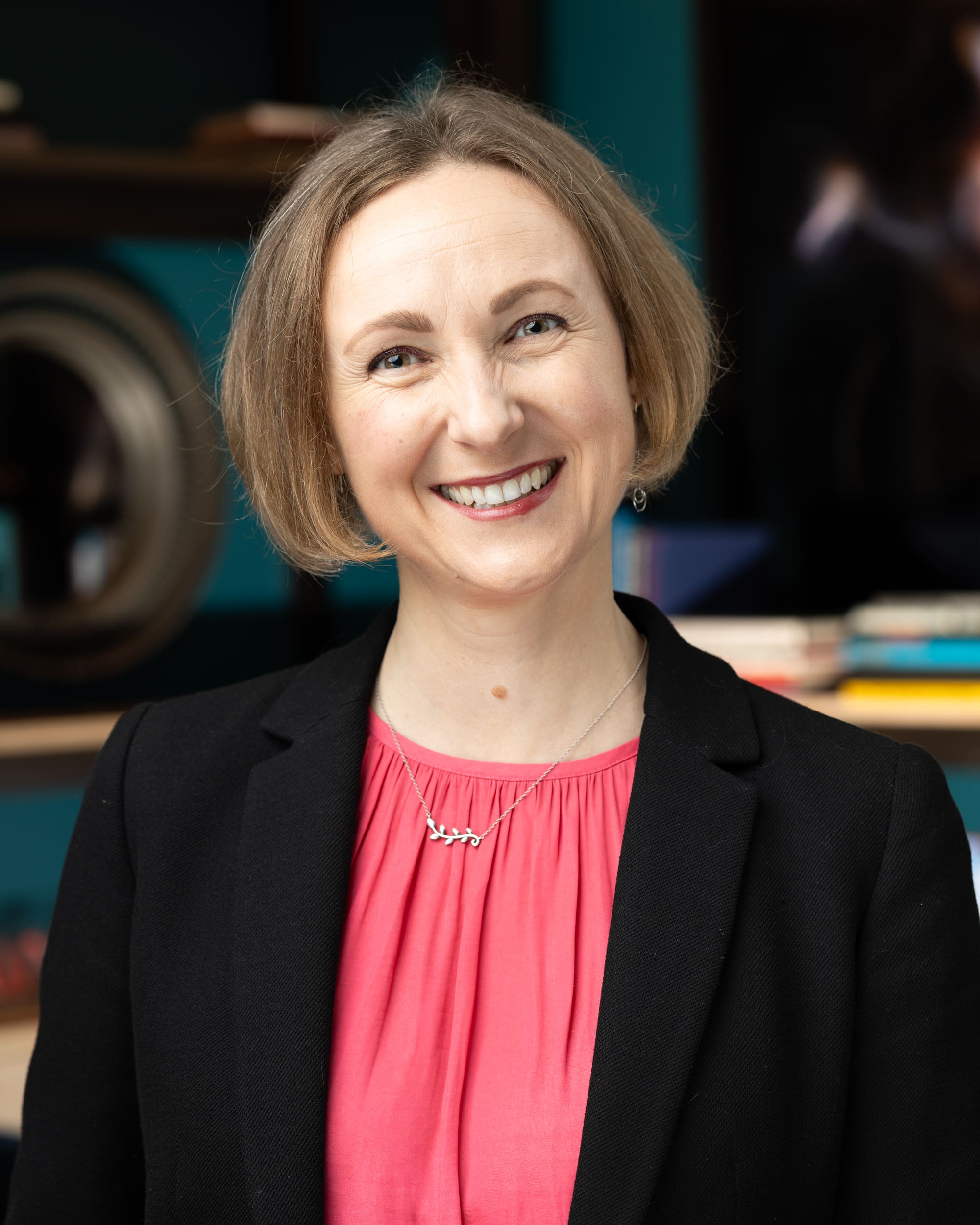 Professional headshot portrait of woman with a smile, corporate photography for events.