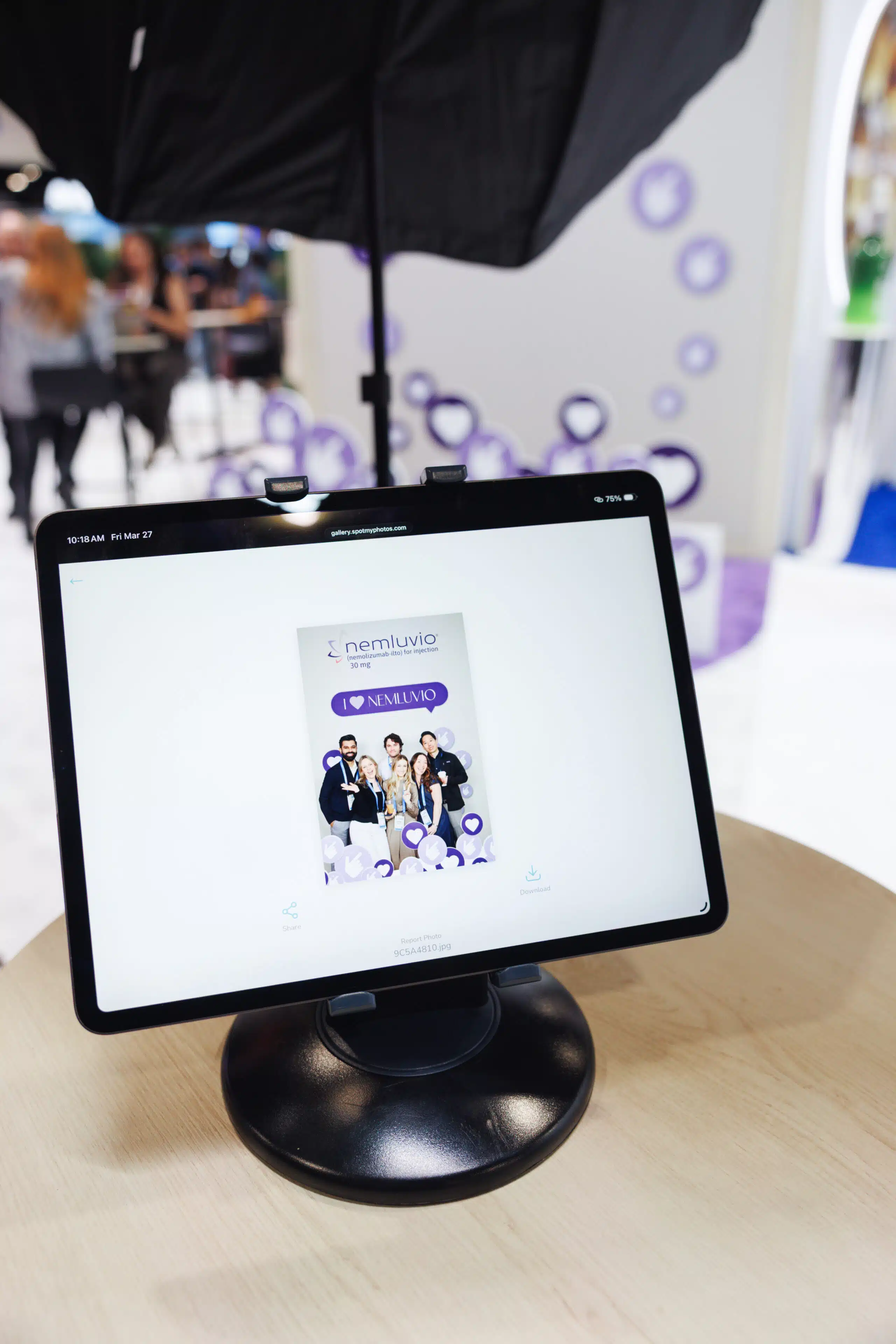 Portrait studio setup with lighting equipment and tablet displaying custom branded microsite.
