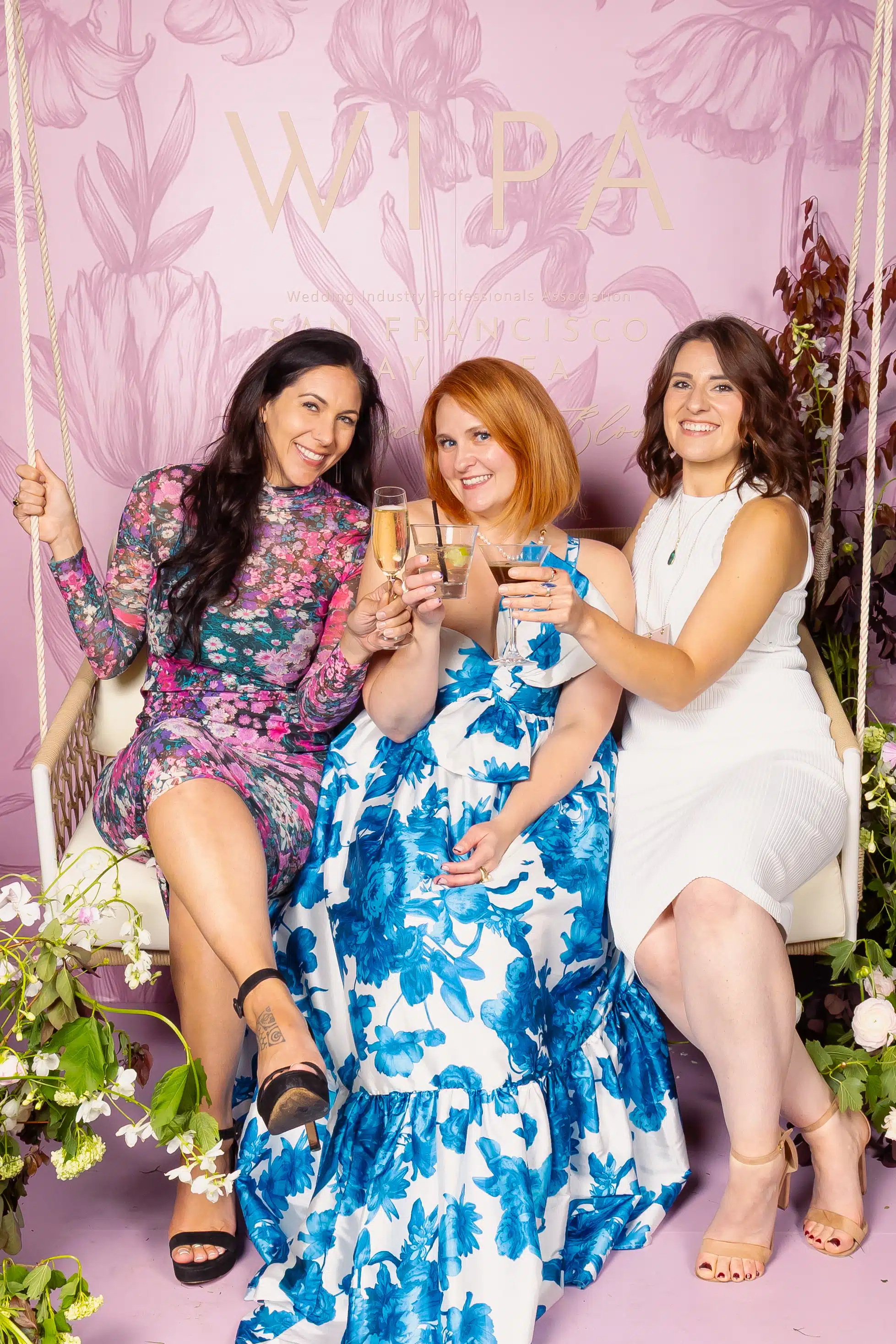 Branded portrait studio setup with guests toasting drinks, custom graphic overlays, and on-site photography experience.