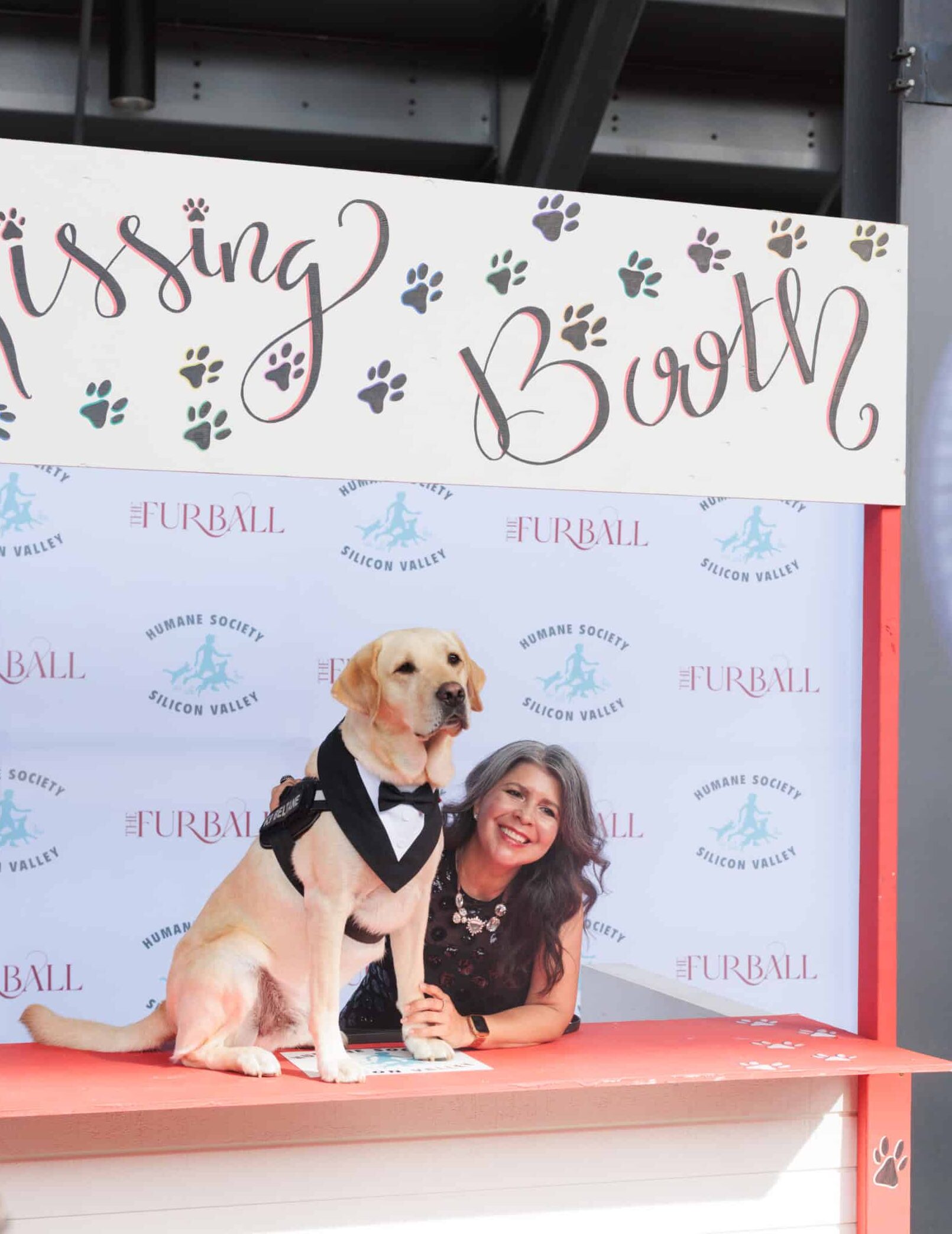Puppy photo op station at The Furball gala with Humane Society Silicon Valley branding and a dog in a tuxedo.