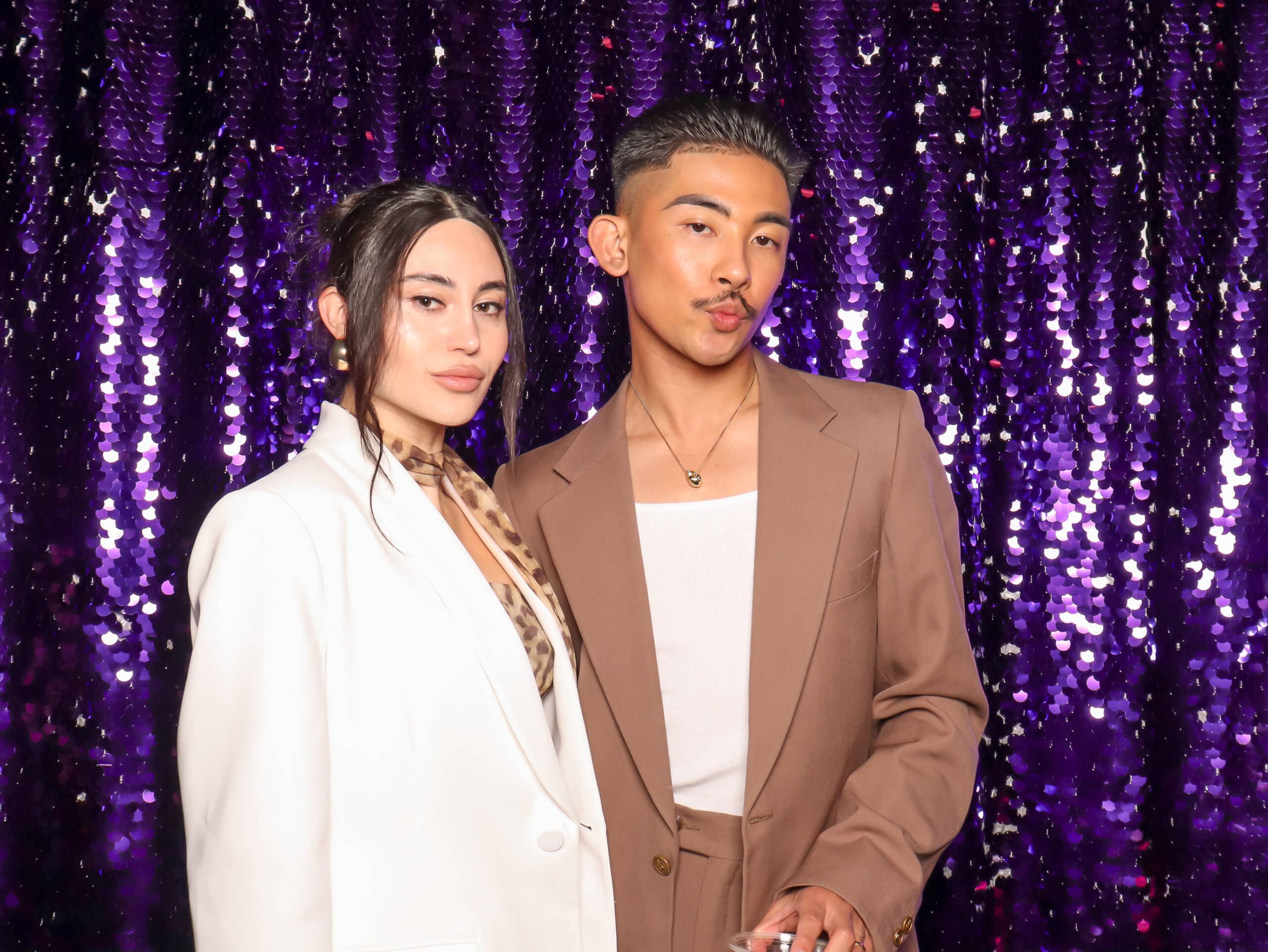 Glam booth portraits of a couple, professional lighting and branded backdrop for a Pop Life Photo experience.