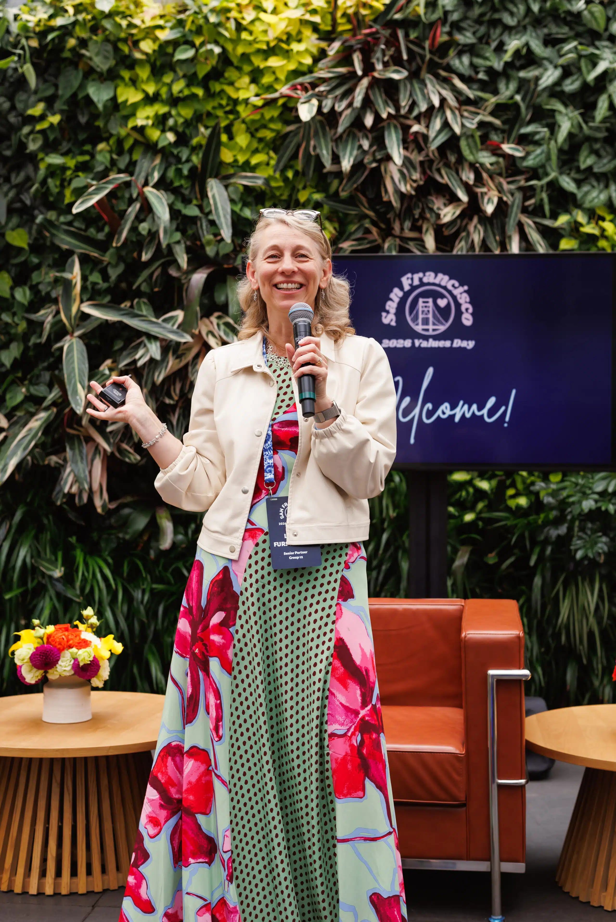 Woman speaking into microphone at event, capturing candid moments and connections.