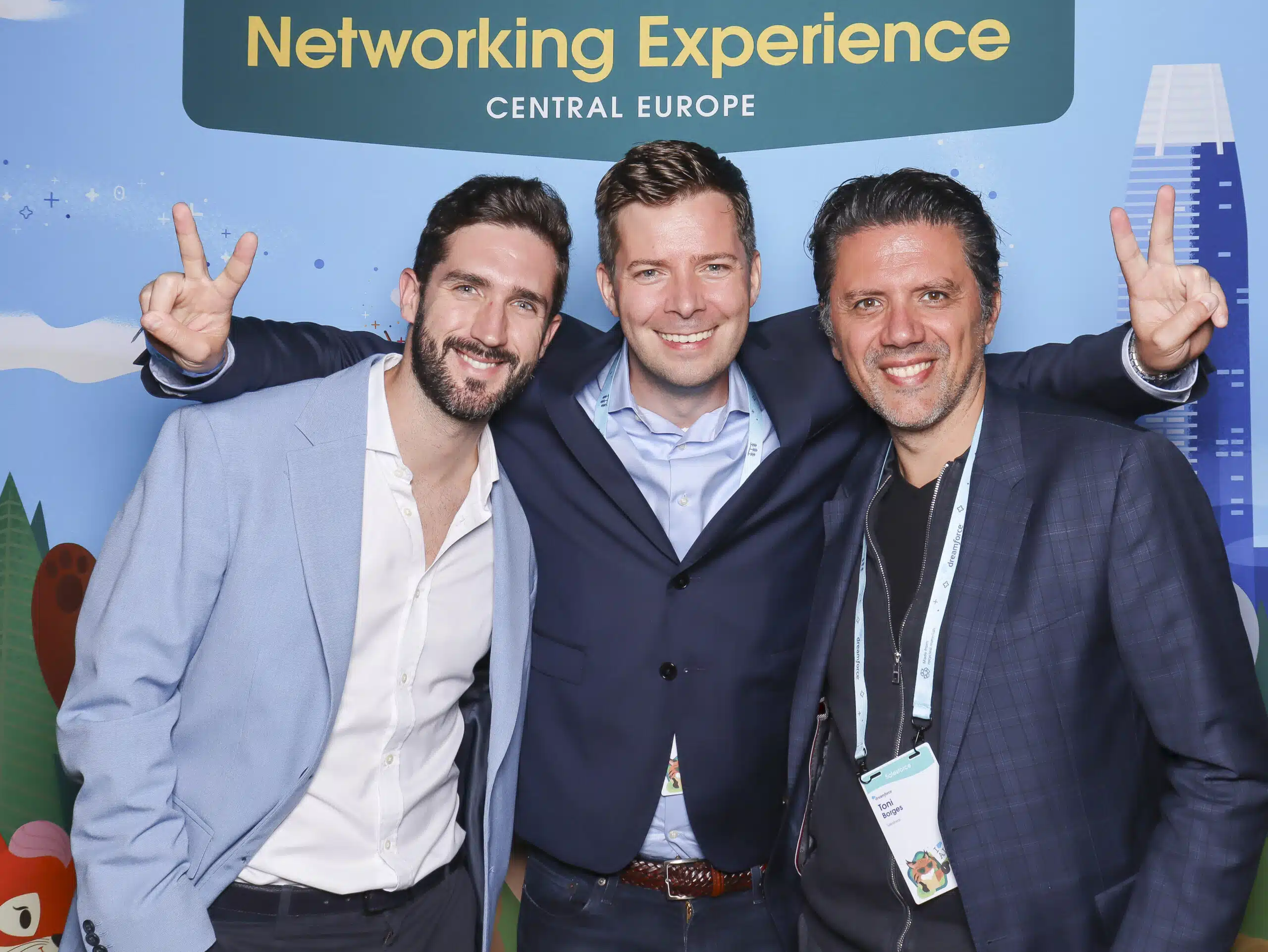 Three men posing for a branded photo booth experience at a conference, Central Europe backdrop.