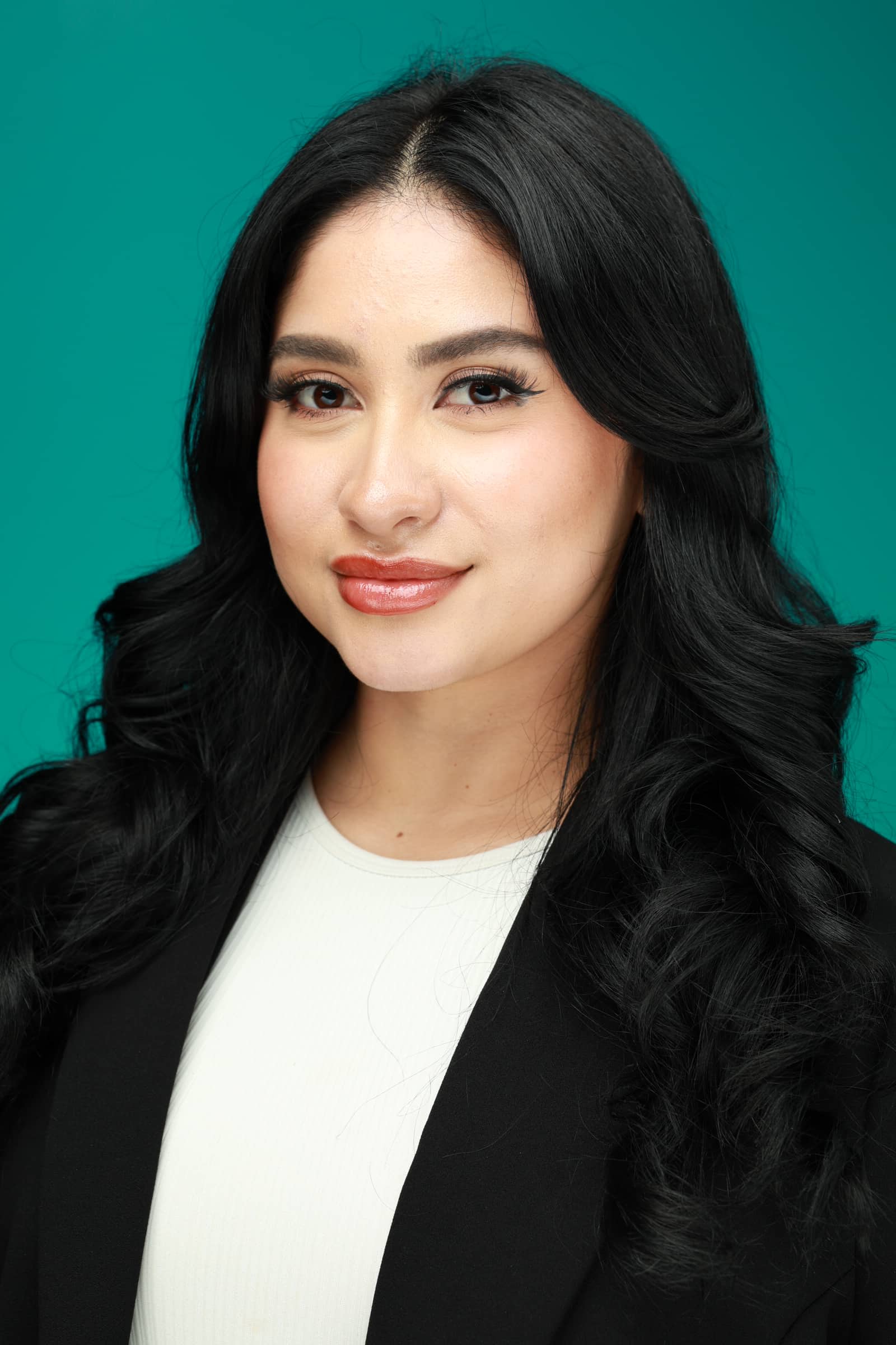 Professional headshot portrait of a woman with styled hair and a blazer, showcasing Pop Life Photo's on-site photography services.