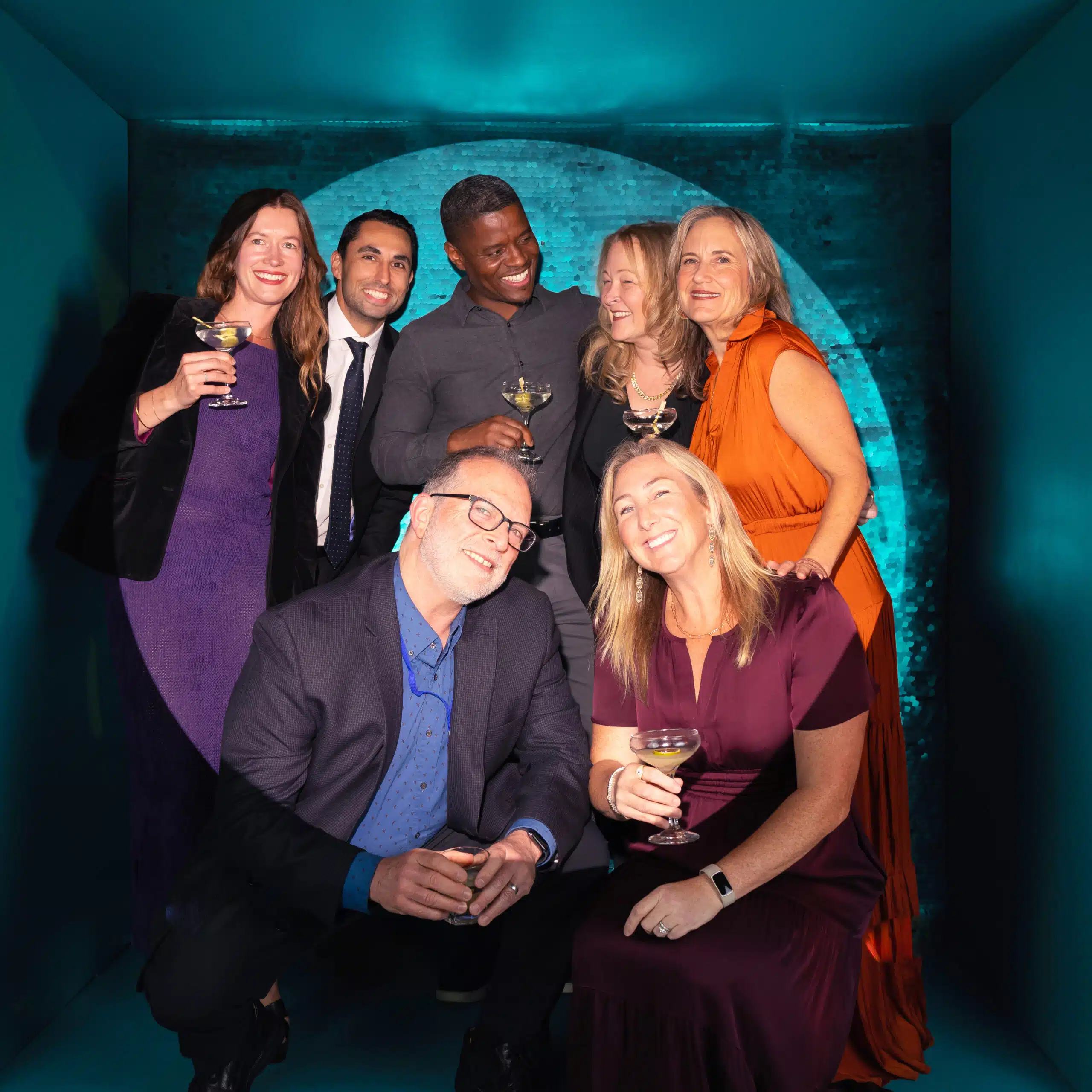 Group portrait at event with custom branded backdrop and instant digital delivery.