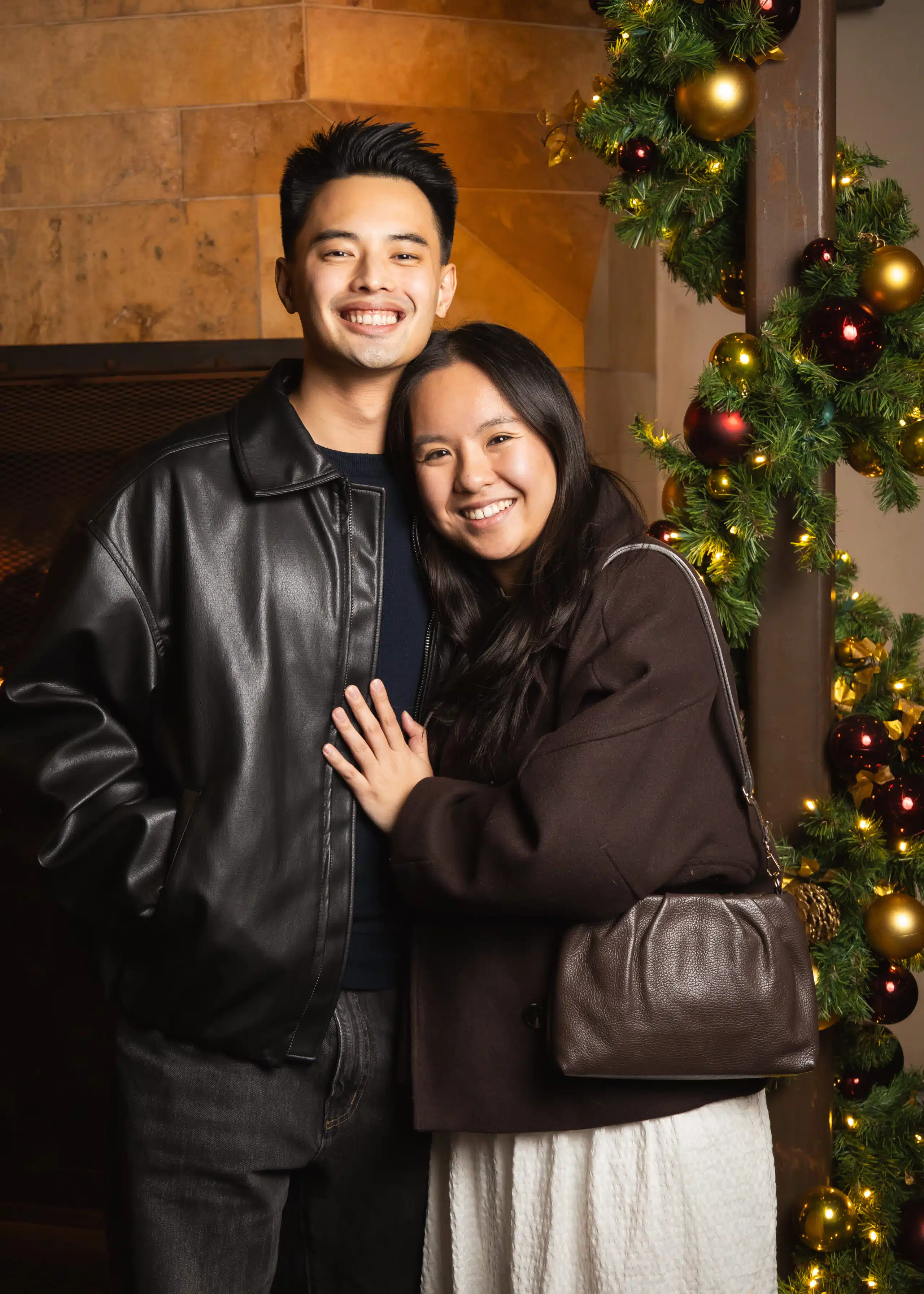 Couple posing for portrait photography with custom branded overlay and on-site printing.