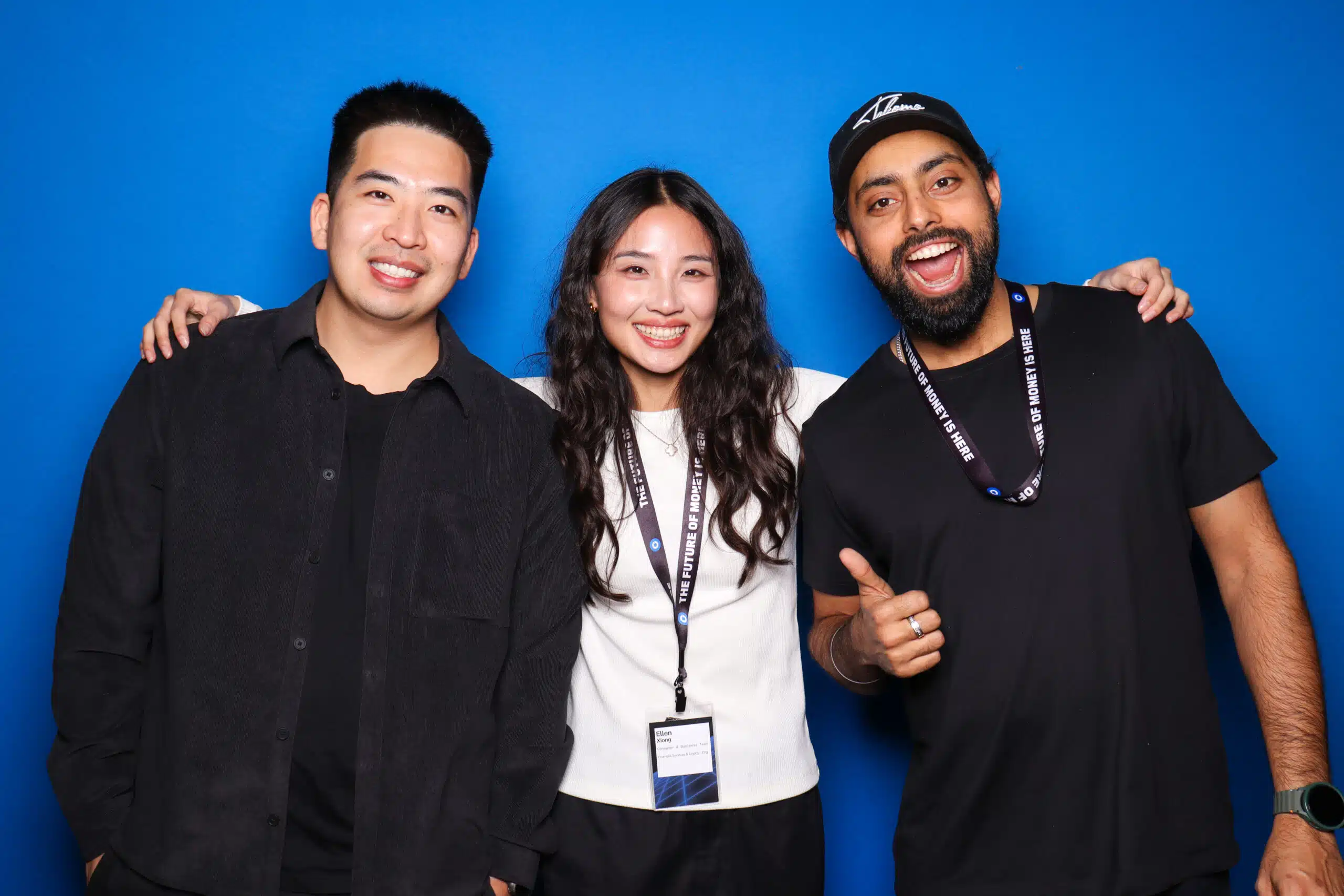 Group of smiling guests enjoying a branded photo booth experience at a corporate event.