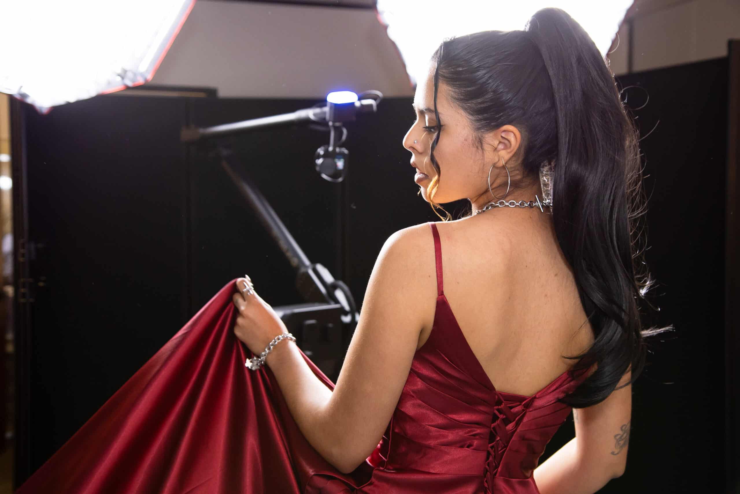 Model posing for Glambot video booth, robotic arm and studio lighting for cinematic slow-motion capture.