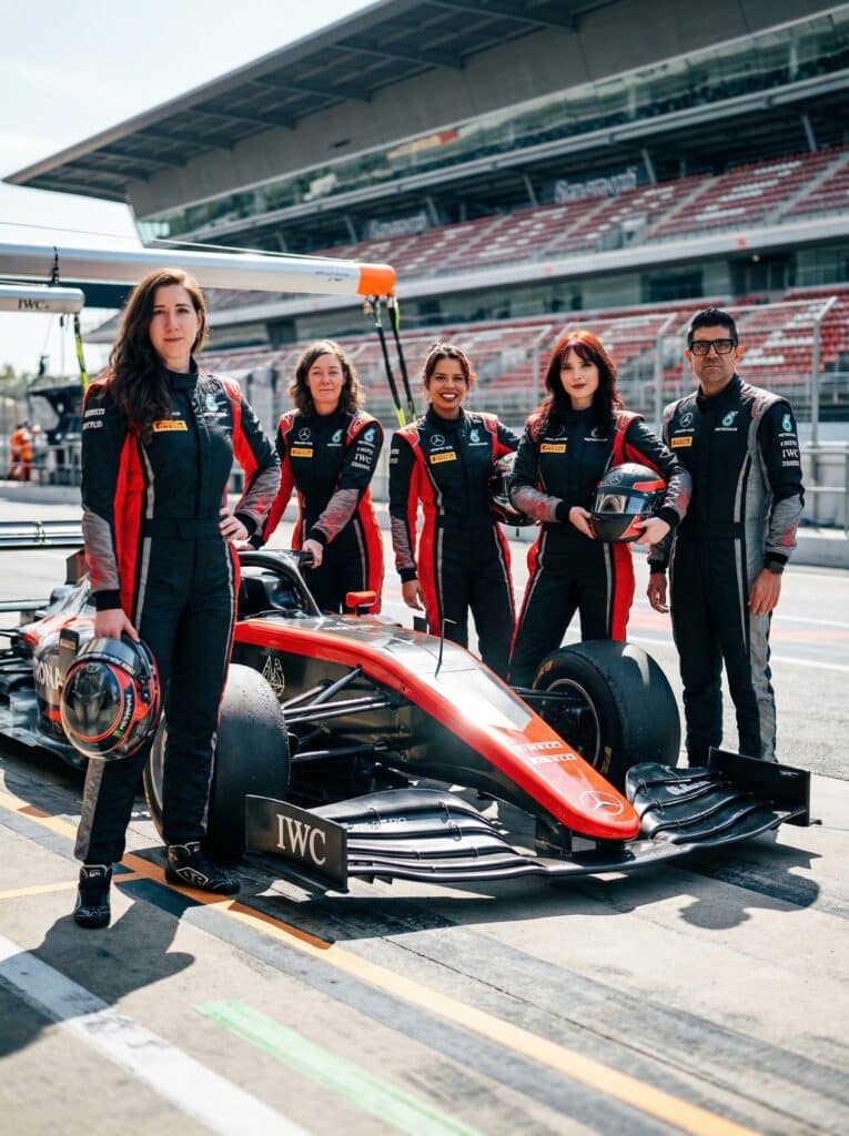 Group of diverse individuals in racing suits beside a sleek Formula 1 car on a racetrack, showcasing a dynamic sports and occupation theme for event photo booths.