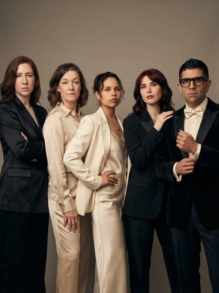 Group of five stylishly dressed individuals in formal attire, embodying a high-fashion aesthetic, set against a neutral background, showcasing elegance and sophistication, relevant to luxury event themes.