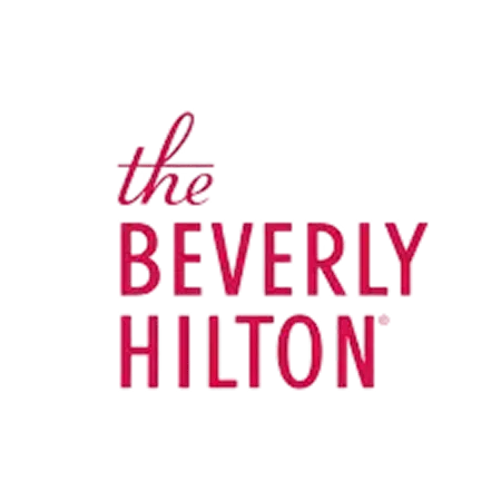 The Beverly Hilton logo, featuring elegant typography in red, representing a luxury venue partner for weddings and events.