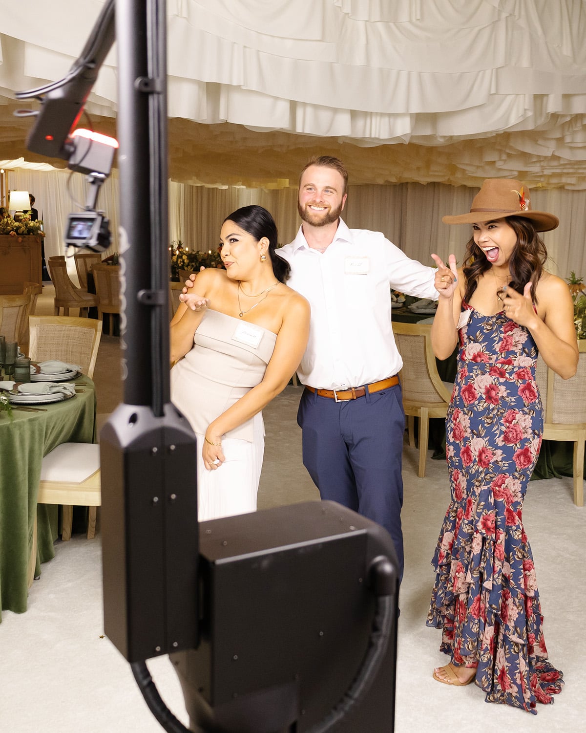 Guests enjoying a glambot photo experience at an upscale event, with a cinematic robot capturing their joyful moments in a beautifully decorated venue.
