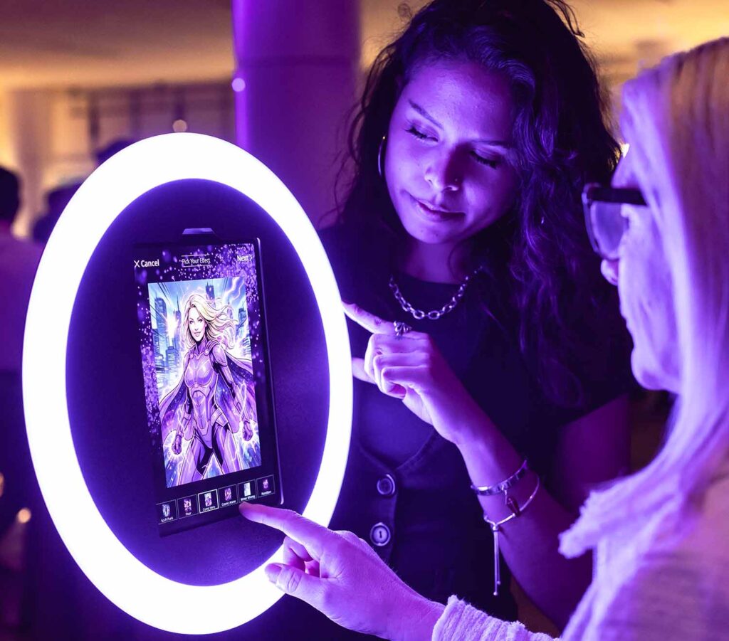 Guests interacting with an AI photo booth, exploring customizable superhero transformations on a digital screen, illuminated by a glowing ring light.