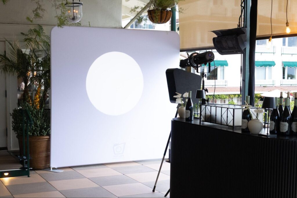 Spotlight Photo Booth setup featuring dramatic lighting and a minimalist backdrop, designed for high-contrast black-and-white portraits in stylish celebrations.