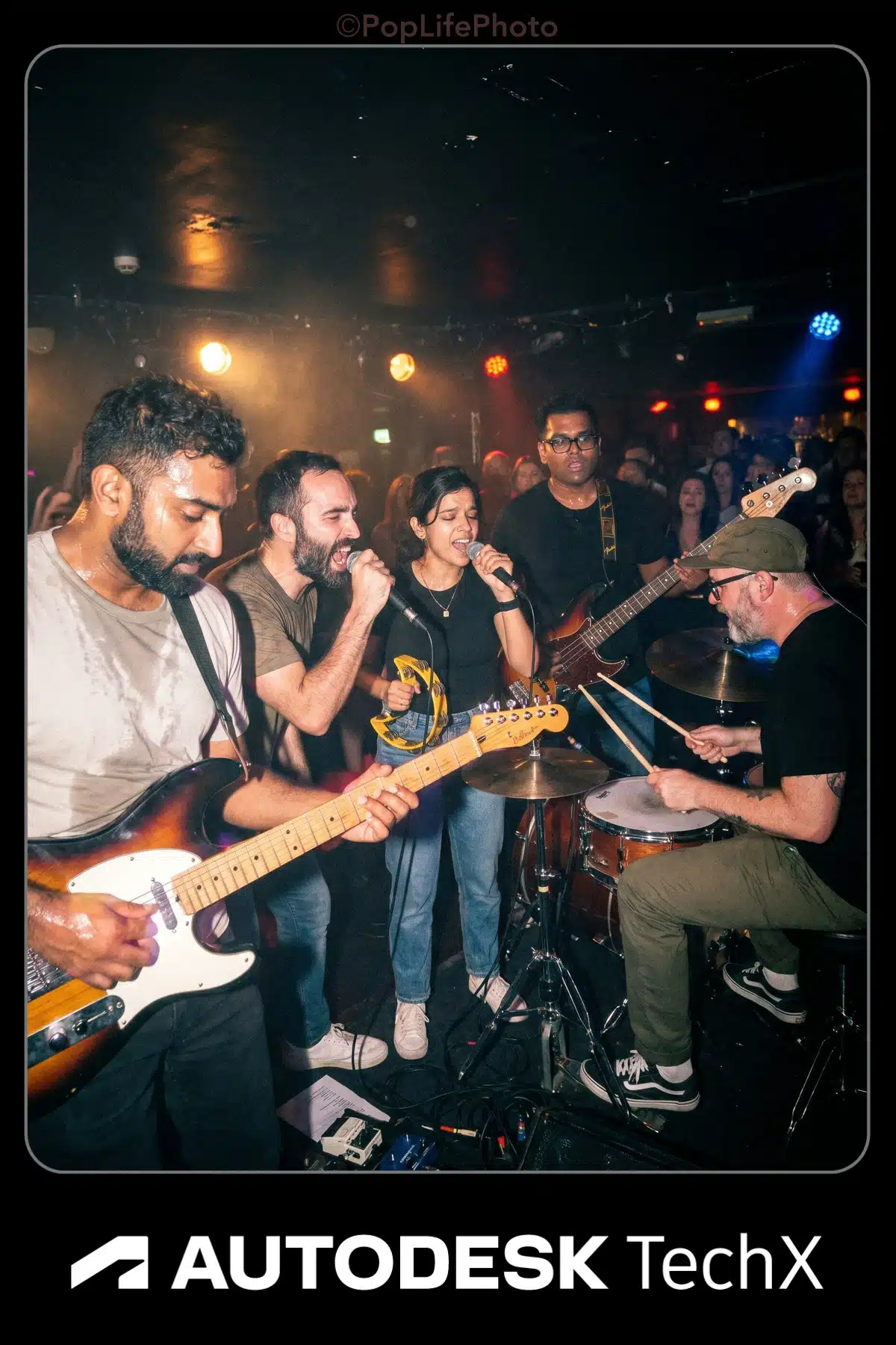 Band performing on stage at event with Pop Life Photo booth and Autodesk TechX branding.