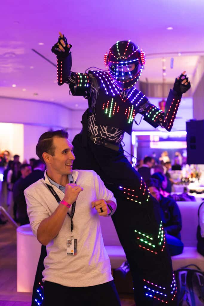 LED performer and guest interacting at an event, capturing candid moments and connections.