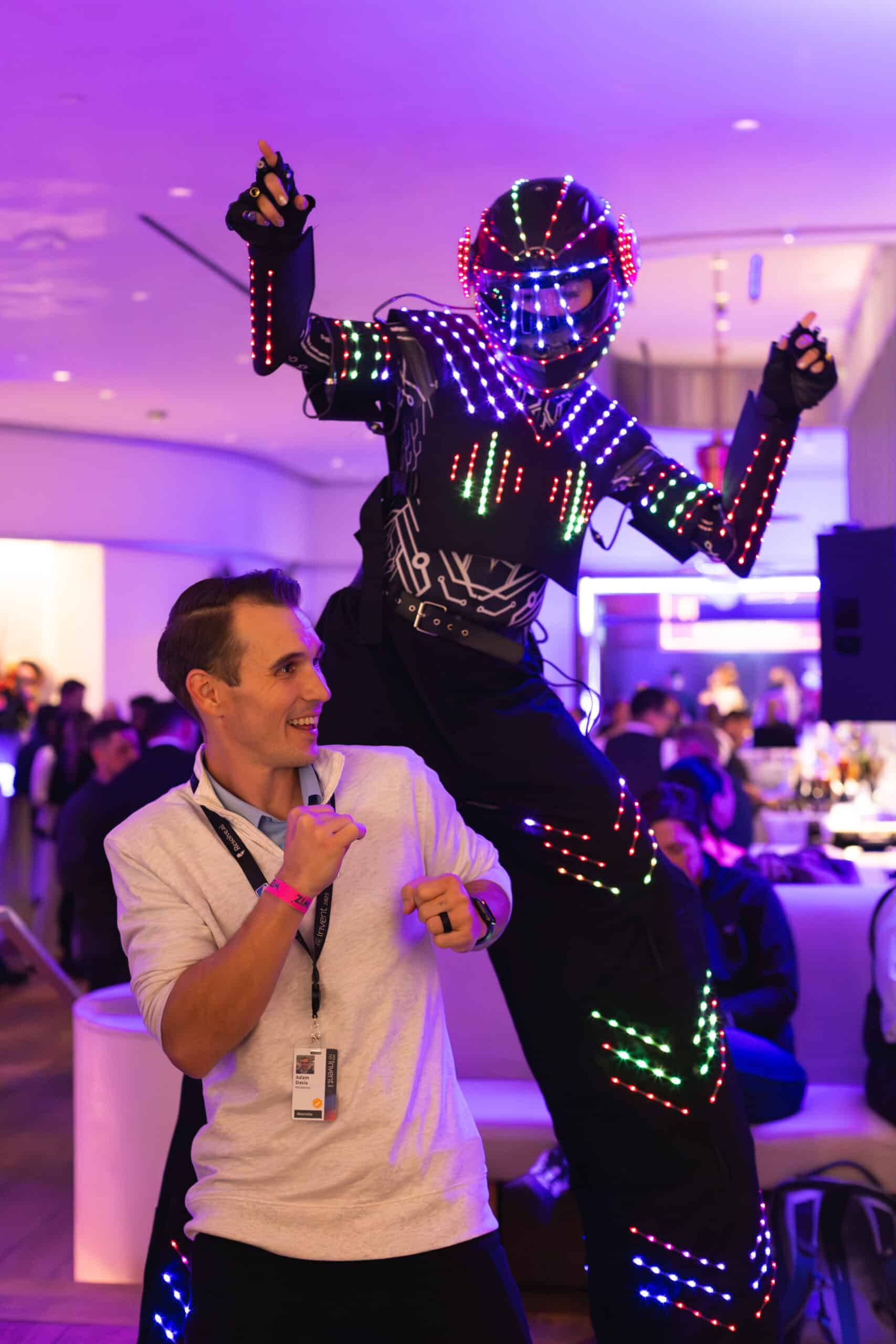 LED performer and guest interacting at an event, capturing candid moments and connections.