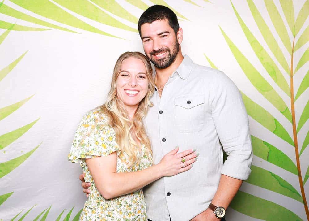 a couple posing for a studio booth experience with colorful pattern backdrop and professional studio lighting