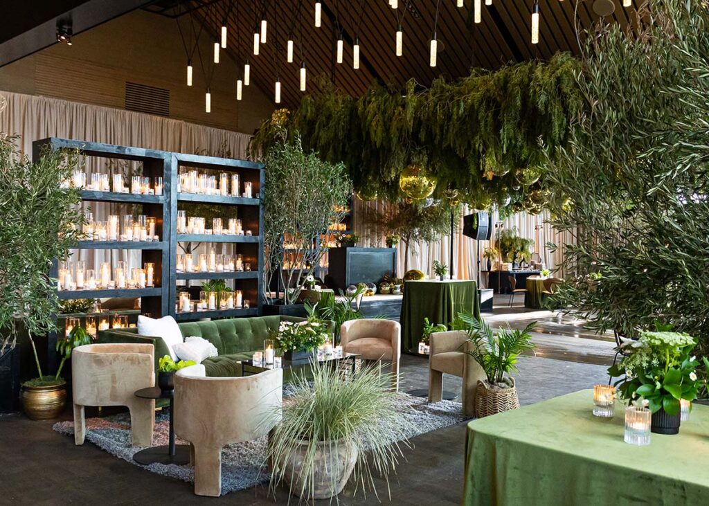 Elegant event space at Stanly Ranch, featuring lush greenery, candle displays, chic seating, and ambient lighting, ideal for weddings and celebrations.
