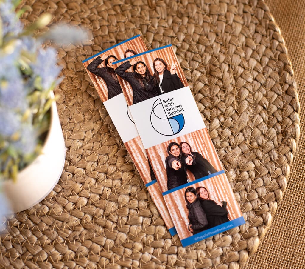 Photo booth strips featuring two women posing playfully at the Safer with Google Summit event, with a sparkling backdrop and branding from Pop Life Photo Booth, emphasizing professional and fun portrait experiences.