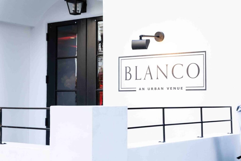 Blanco Urban Venue entrance with sign, showcasing a modern space ideal for corporate events in San Jose.