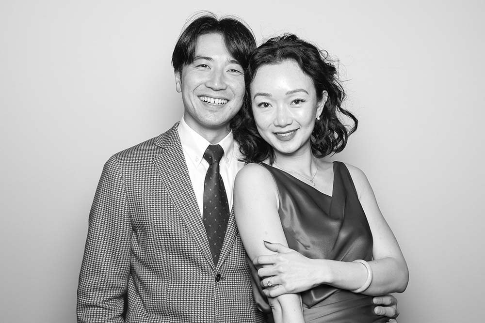 Couple posing joyfully in a photo booth, showcasing engagement and connection, relevant to event photography and marketing potential.