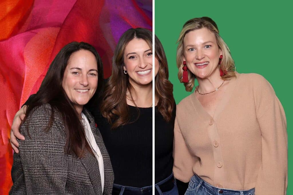Two women posing together in a photo booth, one with a colorful background and the other with a green screen, showcasing a green screen photo booth experience for events.