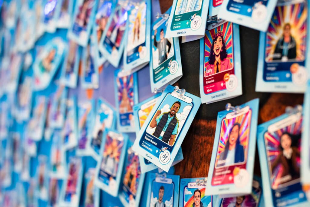Branded AI trading cards displayed on a wall, showcasing diverse portraits and vibrant backgrounds, highlighting the interactive guest experience at corporate events.