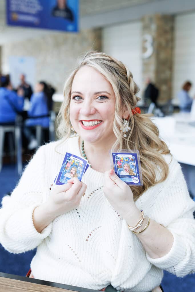 Guest showing off AI Trading Cards at Pop Life Photo's brand activation for Salesforce TDX 2026