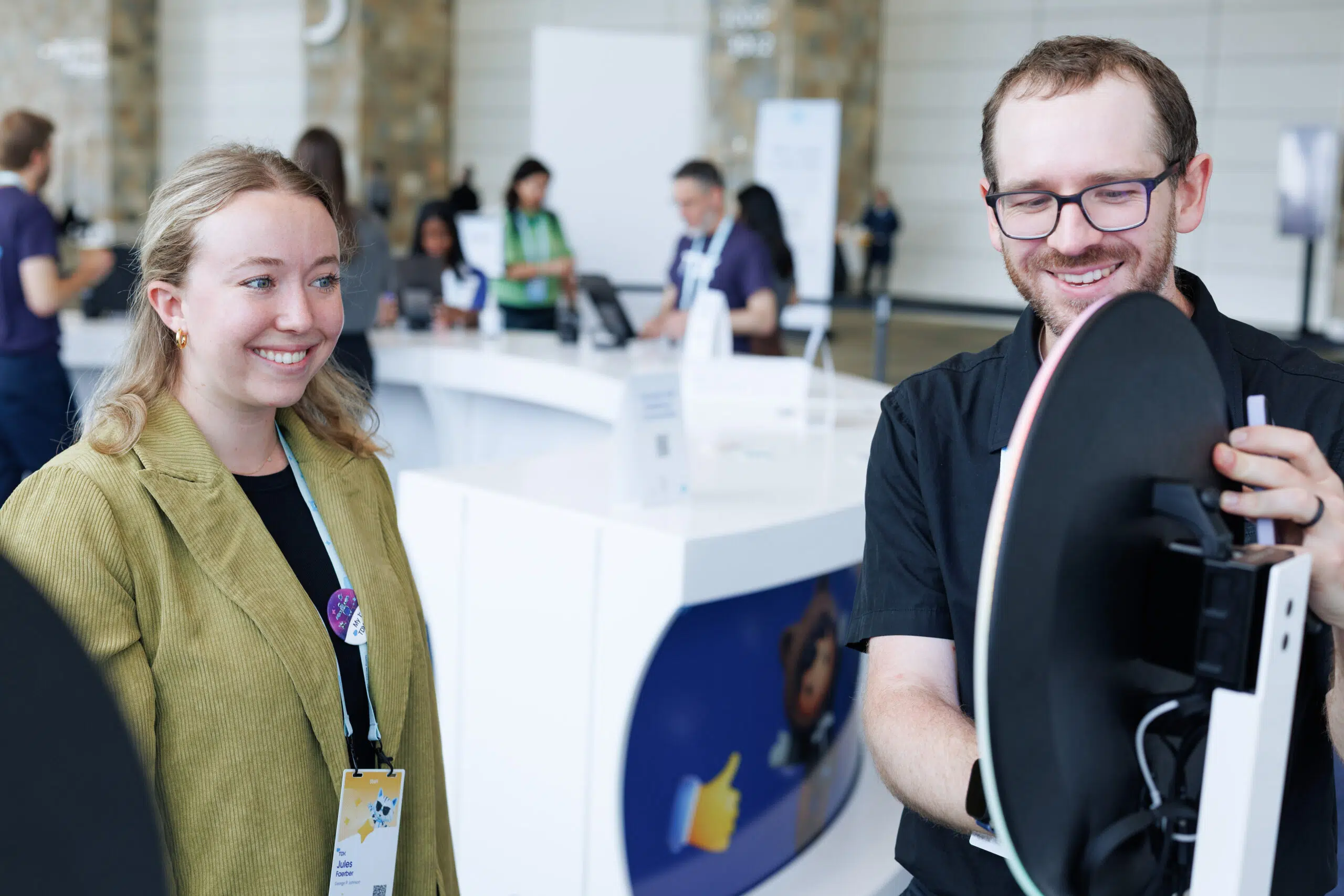 Attendee interacting with staff at Pop Life Photo booth during Salesforce TDX 2026, showcasing custom illustrated character creation and event engagement.