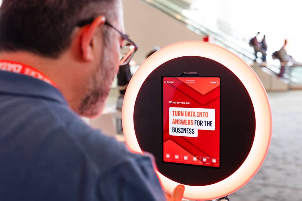 AI photo booth with ring light and interactive screen displaying personalized event content.