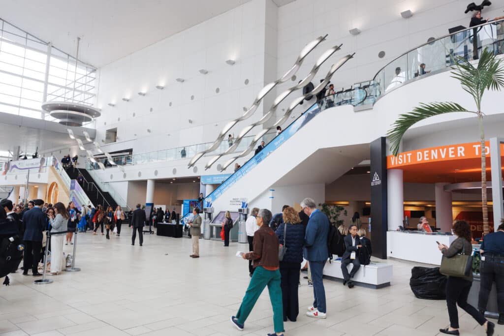 Colorado Convention Center exhibit hall at the 2026 AAD Annual Meeting, Galderma branding and attendee interaction.