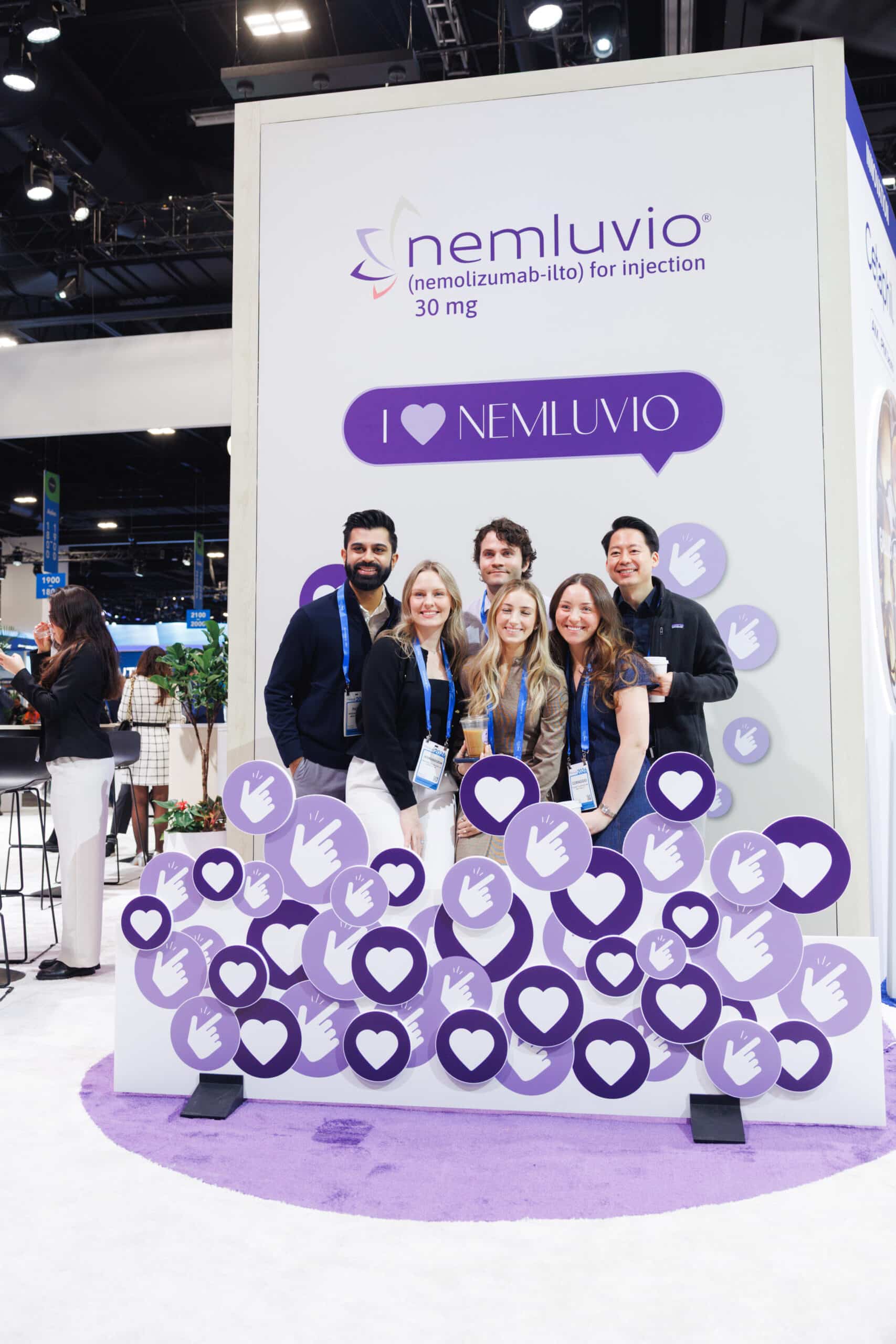 Galderma Nemluvio brand activation backdrop with Pop Life Photo team and attendees posing for portraits.