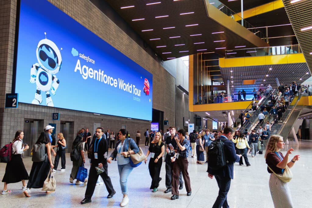 Salesforce World Tour AI Trading Card activation in London, crowd engagement and branded digital display.