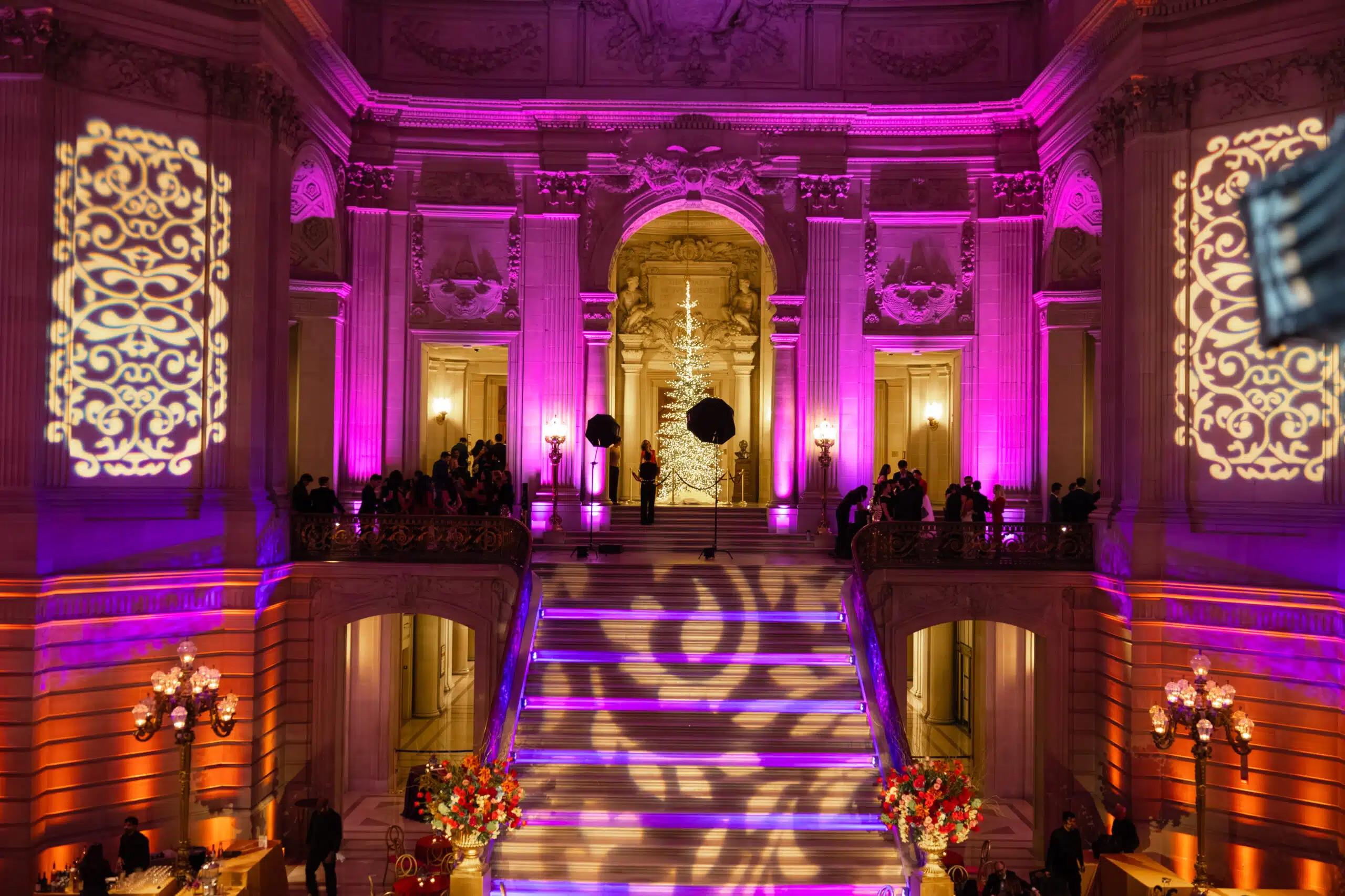 McKinsey holiday celebration at San Francisco City Hall, illuminated with custom lighting and projections.